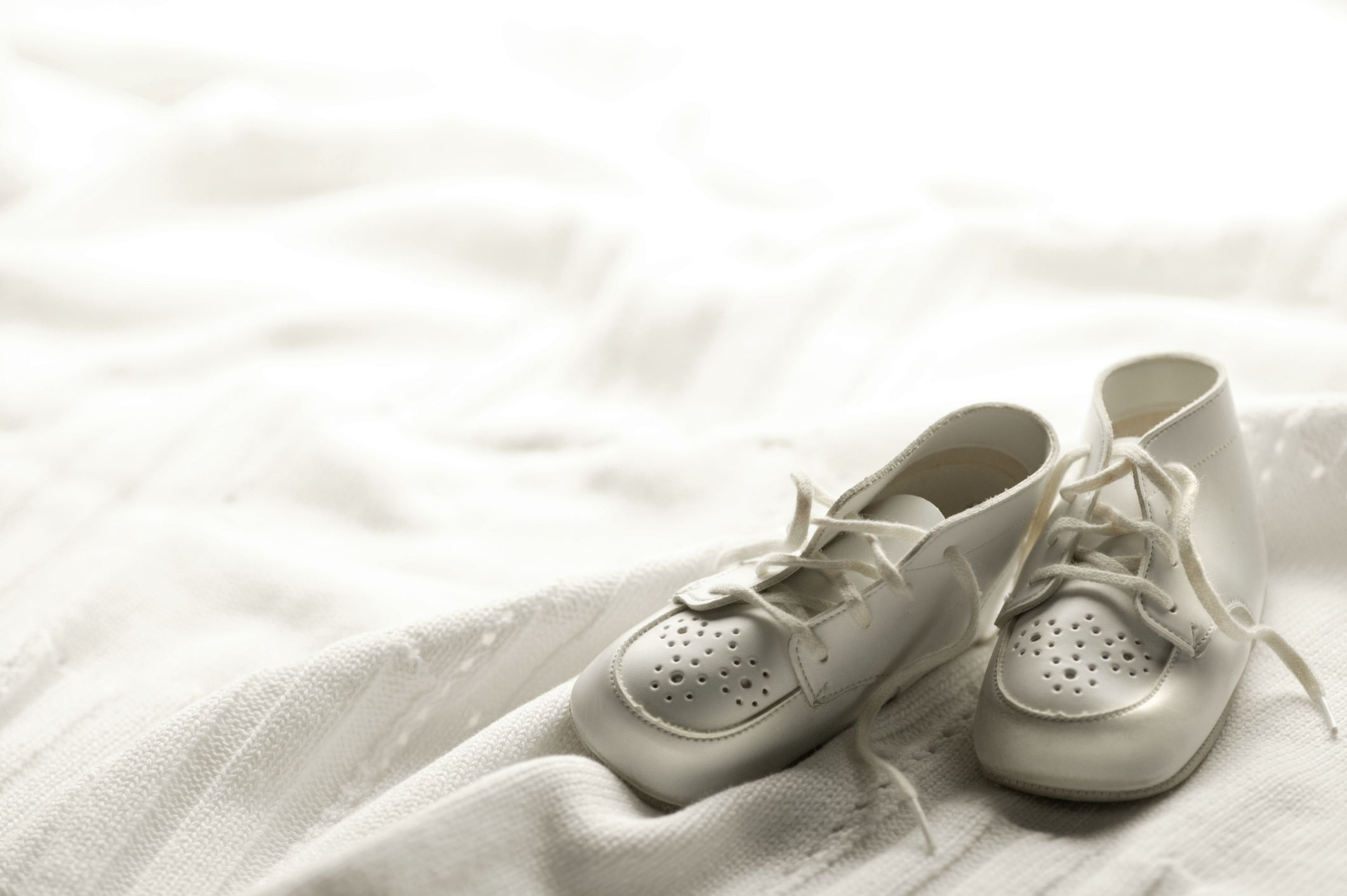 Baby's shoes on baby blanket. Shot with shallow depth of field.